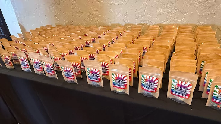 Rows of bagged Mr. B's kits lined up on a table, ready for handout
